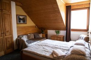 Postel nebo postele na pokoji v ubytování Hetényi Apartmanház és Birtok