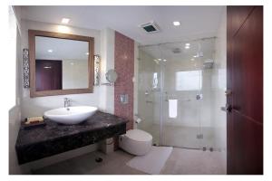 a bathroom with a sink and a toilet and a shower at Sterling Gangtok Orange Village in Gangtok +36 photos