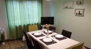 a dining room table with a white table cloth and chairs at Lovely apartment in Pomer in Pomer