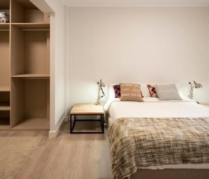 a bedroom with a bed and a side table at GORLIZ Apartment close to the BEACH & Parking in Górliz-Elexalde