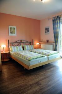 a bedroom with a large bed with two lamps at Ferienweingut Wolfgang Adamy in Kinheim