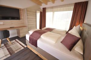 Postel nebo postele na pokoji v ubytování Hotel Martina
