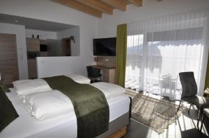 Postel nebo postele na pokoji v ubytování Hotel Martina