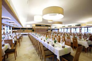 a large banquet hall with tables and chairs at Spirklhof in Bodenkirchen