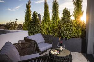 a patio with a couch and a chair and a table at Milestone in Quartu SantʼElena