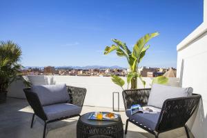 a patio with two chairs and a table on a balcony at Milestone in Quartu SantʼElena