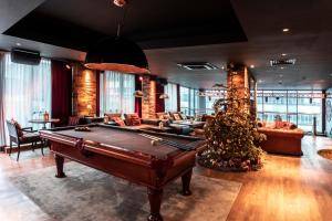 a living room with a pool table and a christmas tree at pentahotel Birmingham in Birmingham