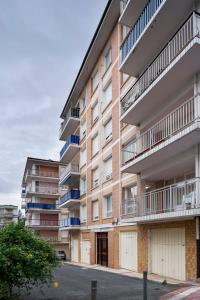 an apartment building with balconies on a street at GORLIZ Apartment close to the BEACH & Parking in Górliz-Elexalde