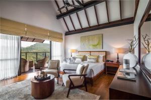 a bedroom with a bed and a living room at Anasa Wellness Resort in Ella