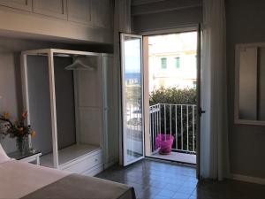 a bedroom with a sliding glass door to a balcony at Residenza Corallina in Tropea