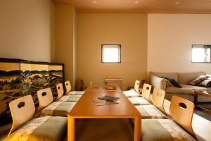 a room with a table and chairs and a couch at bnbplus Sarasa Nara in Nara