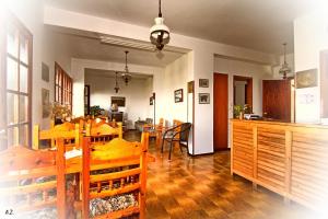 a dining room and living room with a dining table at Hotel Erato in Chorefto