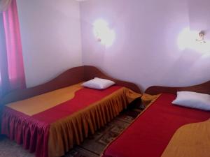 a room with two beds in a room at AeroOtel in Abakan