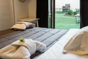 two towels on a bed in a room with a window at Giro nel mondo in Catania