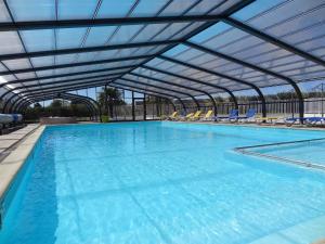 a large swimming pool with an overhead swimming poolvisor at Camping le Rouge Gorge **** 10' Puy du Fou in Saint-Laurent-sur-Sèvre