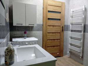 a kitchen with a white sink and a cabinet at Noclegi na Heweliusza in Sanok +73 photos