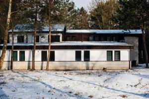 a house in the snow with trees at Villa Lulu Piaseczno in Piaseczno