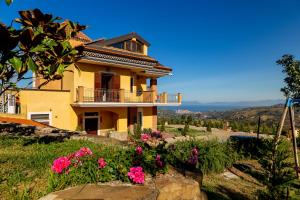 a house on a hill with flowers at Casa Vacanza Villa Aurora in Laureana Cilento