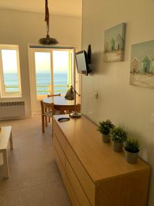 a living room with a view of the ocean at Le COURLIS vue panoramique sur la mer, balcons in Ault