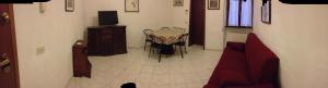 a living room with a chair and a table and a television at Foscolomare in Viareggio +10 photos