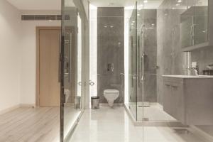 a bathroom with a glass shower and a toilet at Lahoya Homes in Beirut +47 photos
