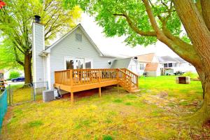 a house with a large wooden deck in the yard at Fountain Road 13701 in Ocean City