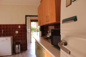 a kitchen with a counter with a sign on the refrigerator at Kismet Farm in Muldersdrift