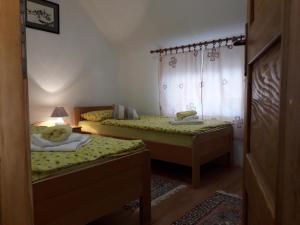 a bedroom with two beds and a window at Apartment Mrsinj in Korenica