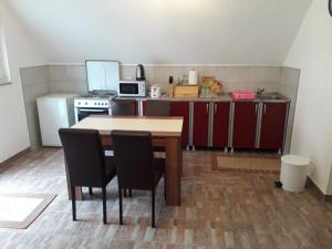 a small kitchen with a table and chairs in it at Apartment Mrsinj in Korenica