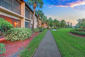 a walkway in front of a building with palm trees at Alhambra Villas by Coolvacay in Kissimmee
