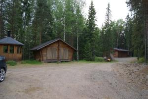 a couple of wooden cabins in a forest at Hevossilta in Forssa