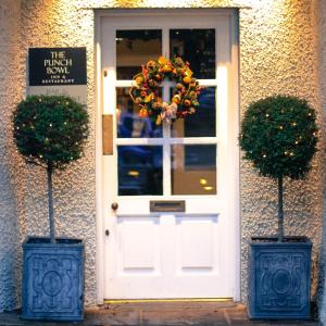 a white door with a wreath in front of a building at The Punch Bowl Inn in Kendal