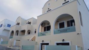 a building with a sign on the side of it at Antonia Apartments in Fira