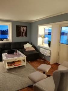 a living room with a couch and a coffee table at Seaview apartment Karmøy in Sæveland