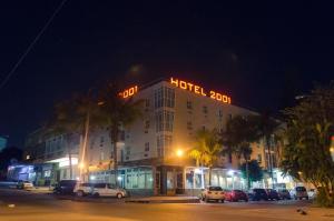 a hotel with a hotel sign on top of it at night at Hotel 2001 in Maputo