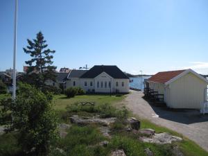 a group of buildings next to a body of water at Badholmens Vandrarhem in Fjällbacka