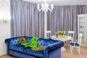 a blue couch in a living room with a table at Hotel Kyiv in Kyiv