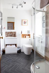 a bathroom with a shower and a toilet at Ceol na Mara Guest House in Tarbert