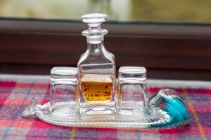 a bottle and two glasses sitting on a table at Ceol na Mara Guest House in Tarbert
