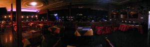 a restaurant with a bar with red tables and chairs at Inle Star Hotel in Nyaungshwe Township