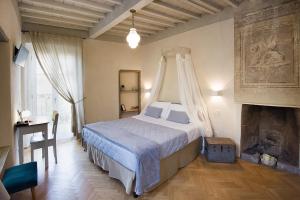 a bedroom with a bed with a canopy in it at Il Piccolo Cavour Charming House B&B in Arezzo