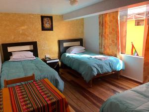 Katil atau katil-katil dalam bilik di Hostal Qolqampata