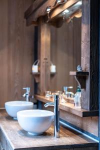 a bathroom counter with two sinks and a mirror at Bright airy spacious apartment in Passy