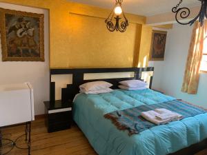 Katil atau katil-katil dalam bilik di Hostal Qolqampata