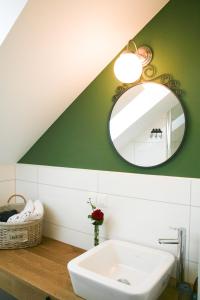 a bathroom with a sink and a mirror at Landgasthof Friedl in Sankt Lorenzen bei Knittelfeld