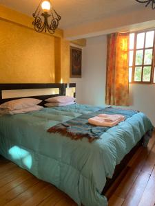 Katil atau katil-katil dalam bilik di Hostal Qolqampata