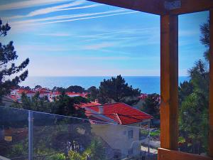 a view of the ocean from the balcony of a house at Residencia Praia Norte - AL in Nazaré