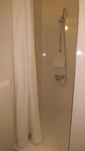 a bathroom with a shower with a shower curtain at L'Oustau in Cavaillon +13 photos