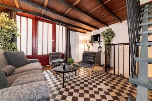 a living room with a couch and a table at Architect's Triplex - Haut Marais in Paris