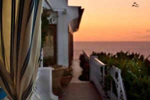 a stairway leading to a balcony with the ocean at Le Querce Resort Sea Thermae & Spa in Ischia